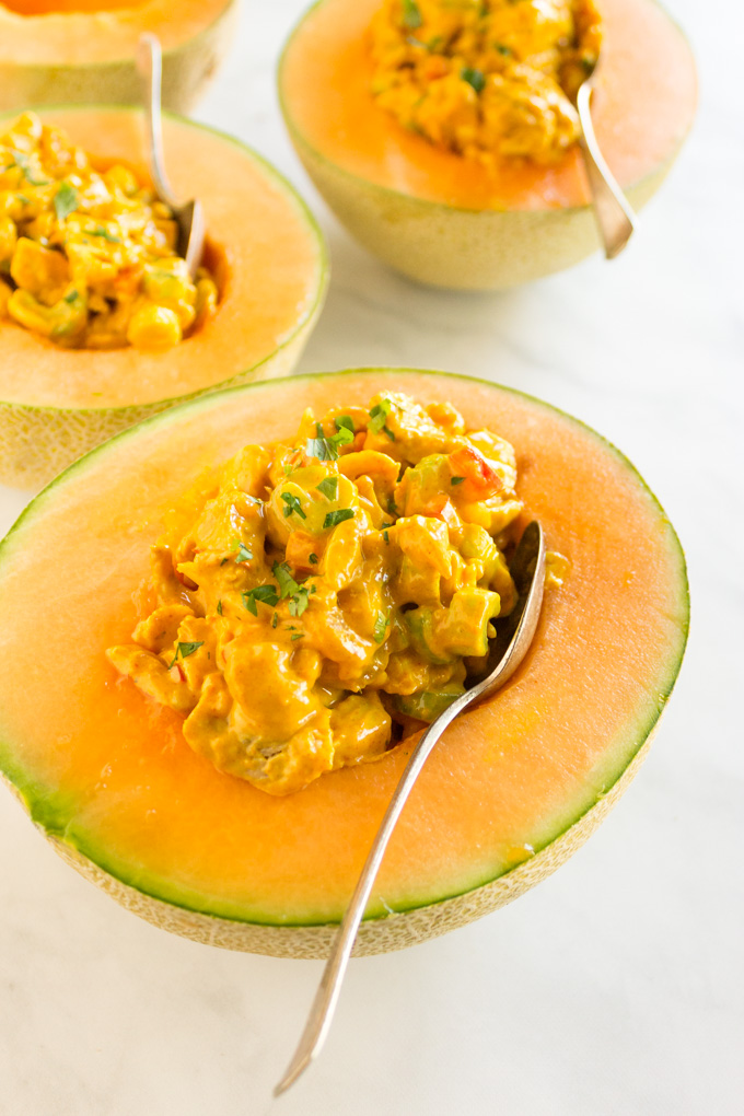 Curried chicken salad in cantaloupe boats is the perfect summer meal for a party or simple weeknight dinners. Only takes 15 minutes to make! It's served cold or room temperature and requires no cooking. #summer #chickensalad #easyrecipe #chicken #glutenfree #dairyfree #entree #curry #chickenrecie #cantaloupe #mealprep | robustrecipes.com
