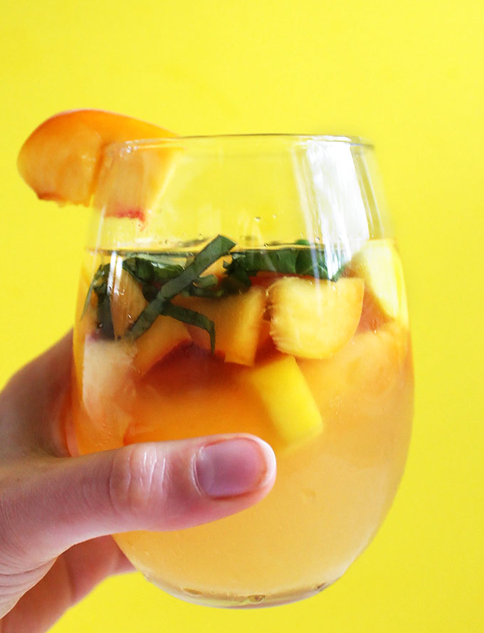 Peach Mango Sangria. Bursting with peaches and mangos! So easy to make! Summertime in a pitcher. #sangria #summercocktail #refinedsugerfree #recipe | robustrecipes.com