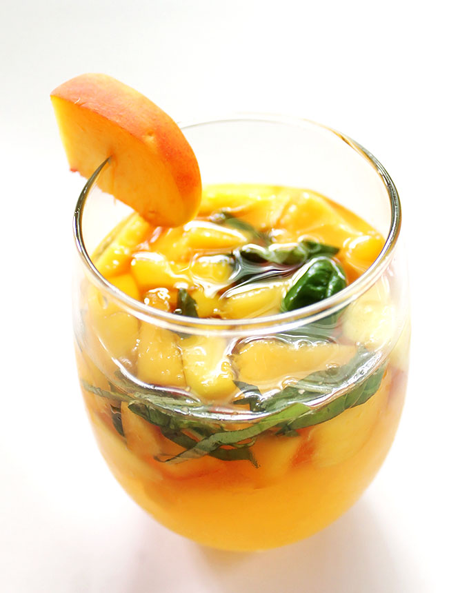 Peach Mango Sangria. Refreshing. Juicy and sweeet! Packed with fruit! #sangria #summercocktail #recipe | robustrecipes.com