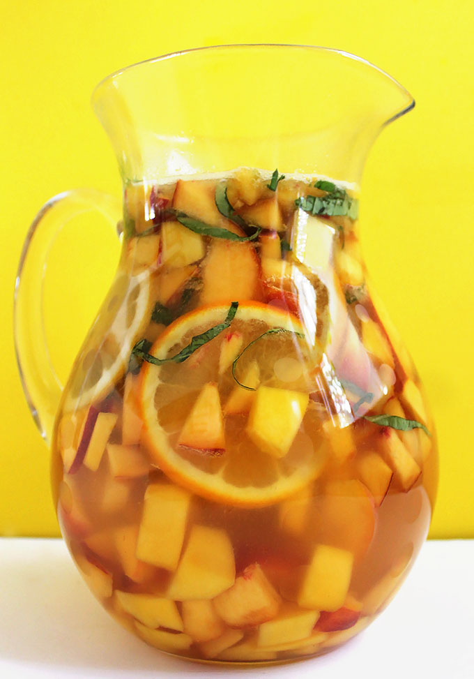 Peach Mango Sangria. SO easy to make. Refreshing, delicious. It's like summertime in a glass! #sangria #summercocktail #recipe | robustrecipes.com