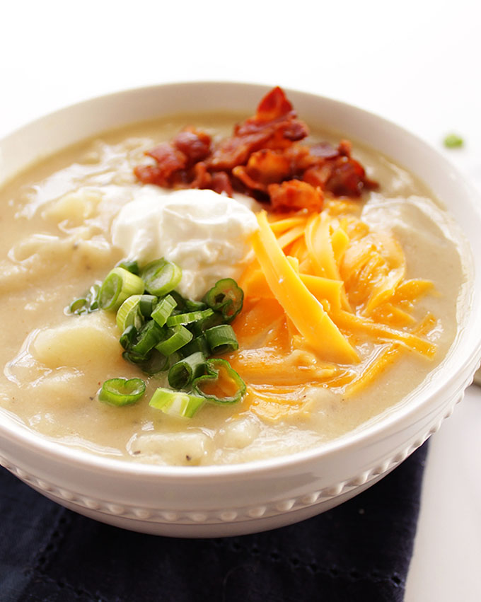 Healthier Loaded Baked Potato Soup - Secret ingredient: pureed cauliflower instead of cream! So yummy! Topped with bacon, sour cream, onions, and cheese! A gluten free recipe! | robustrecipes.com