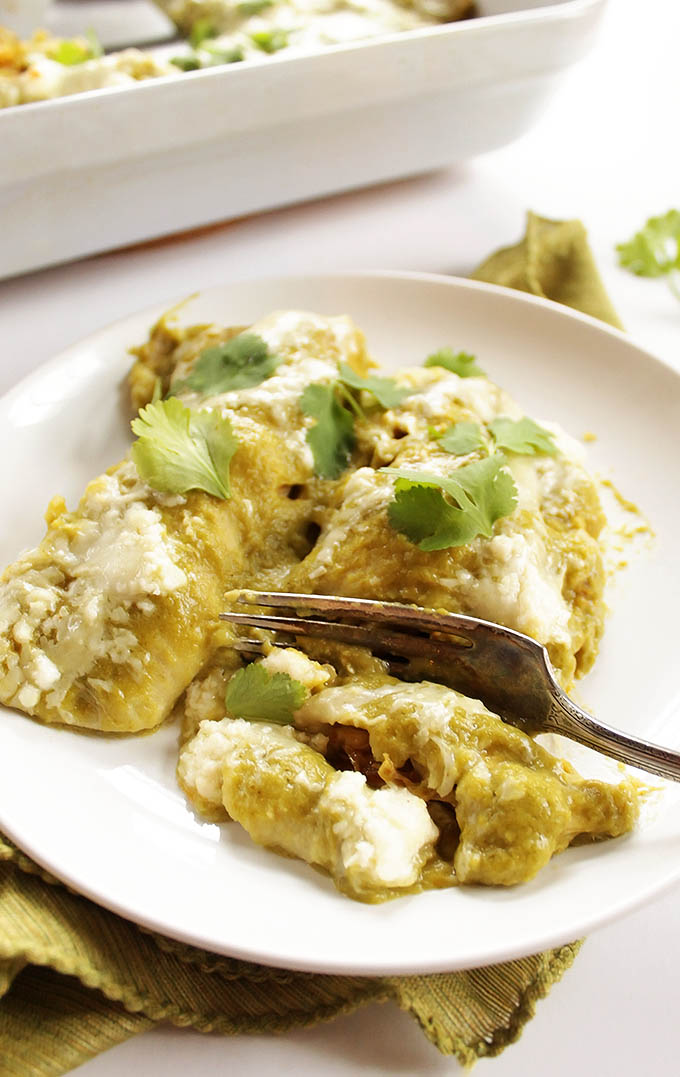 Easy Green Chicken Enchiladas - Stuffed with cheese, shredded chicken, and topped with roasted green enchilada sauce. Perfect meal for weeknight or entertaining! Gluten Free | robustrecipes.com