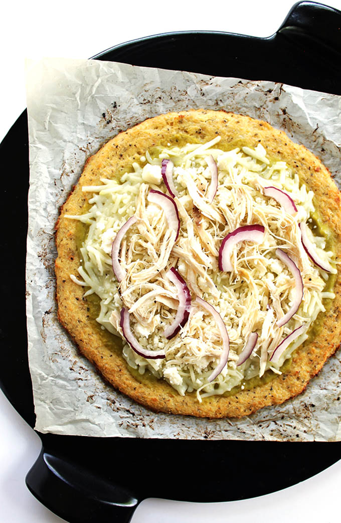 Green Chicken Enchilada Pizza - All of the enchilada fixings on top of a crispy, nutritious easy cauliflower pizza crust. This recipe is husband approved! Gluten Free. | robustrecipes.com