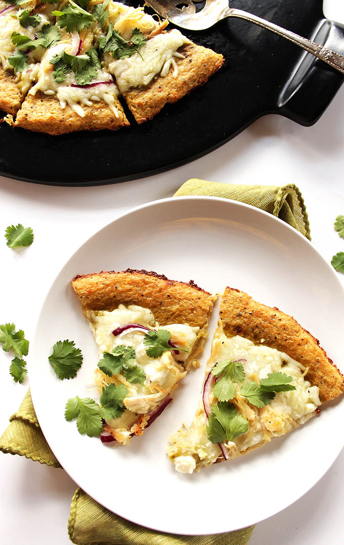 Green Chicken Enchilada Pizza - Roasted green enchilada sauce, cheese, red onion, chicken, fresh cilantro all on top of a crispy easy cauliflower pizza crust! This recipe is husband approved! Gluten Free. | robustrecipes.com