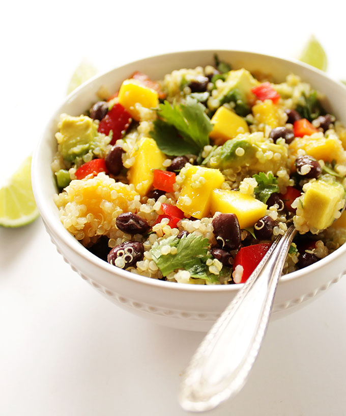 Mango black Bean Quinoa Salad - A refreshing summertime salad packed with mango, avocado, and red pepper! EASY recipe to make, comes together in 25 minutes. Served cold, perfect for summer parties. Filling enough for a meal, 10 grams protein, or great as a side salad. Vegan/Gluten Free.
