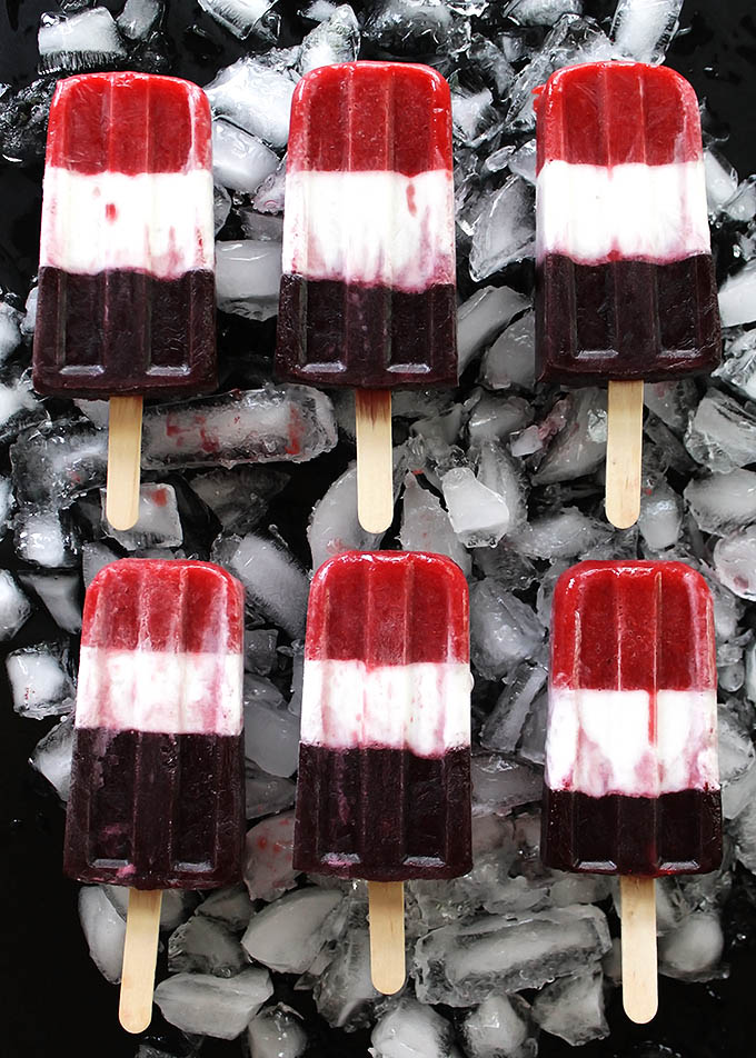 Vegan Red White and Blue Popsicles - EASY, healthy 4th of July treat. Pureed strawberries, coconut milk, and pureed blueberries make the layers. Refreshing, fun recipe! Vegan/gluten free/ refined sugar free.
