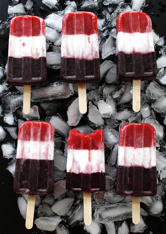 Vegan Red White and Blue Popsicles -Refreshing, EASY, healthy and festive 4th of July recipe. Pureed strawberries, coconut milk, and pureed blueberries make up the layers. Vegan/gluten free/ refined sugar free.