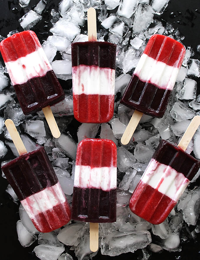 Vegan Red White and Blue Popsicles - EASY, healthy, tasty 4th of July treat. Pureed strawberries, coconut milk, and pureed blueberries make the layers. Refreshing, festive, and fun! Refined sugar free/gluten free/vegan