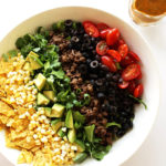 Healthy Taco Salad - Crunchy shredded romaine lettuce piled high with the best taco toppings and drizzled with a salsa lime vinaigrette. This easy recipe is perfect for summer! Gluten Free.