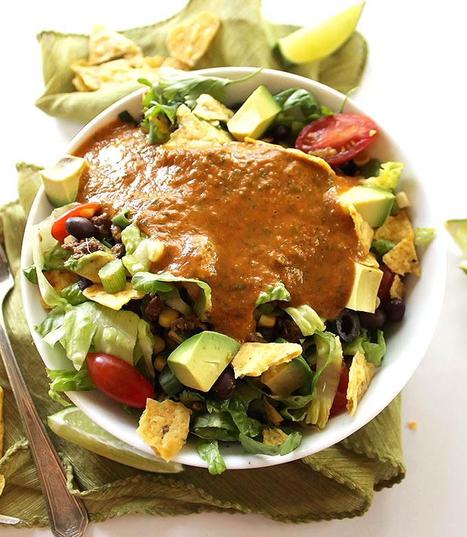 Healthy Taco Salad - Shredded romaine lettuce topped with all your favorite taco fixings with an easy salsa lime vinaigrette! We love this recipe in the summer! Gluten Free.