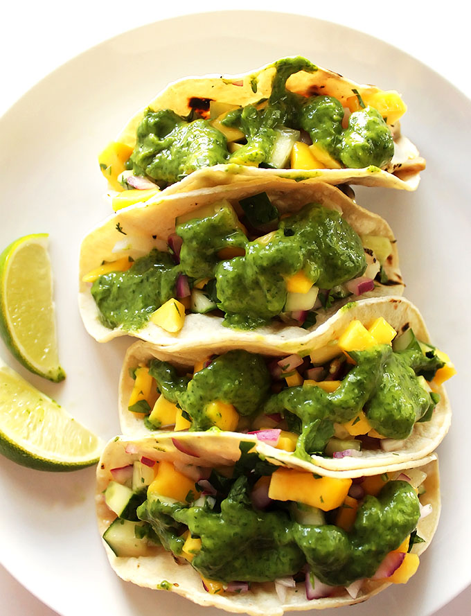 Fish Tacos with Mango Cucumber Pico De Gallo and Cilantro - A healthy, light, easy summertime recipe that comes together in 20 minutes! Gluten free.