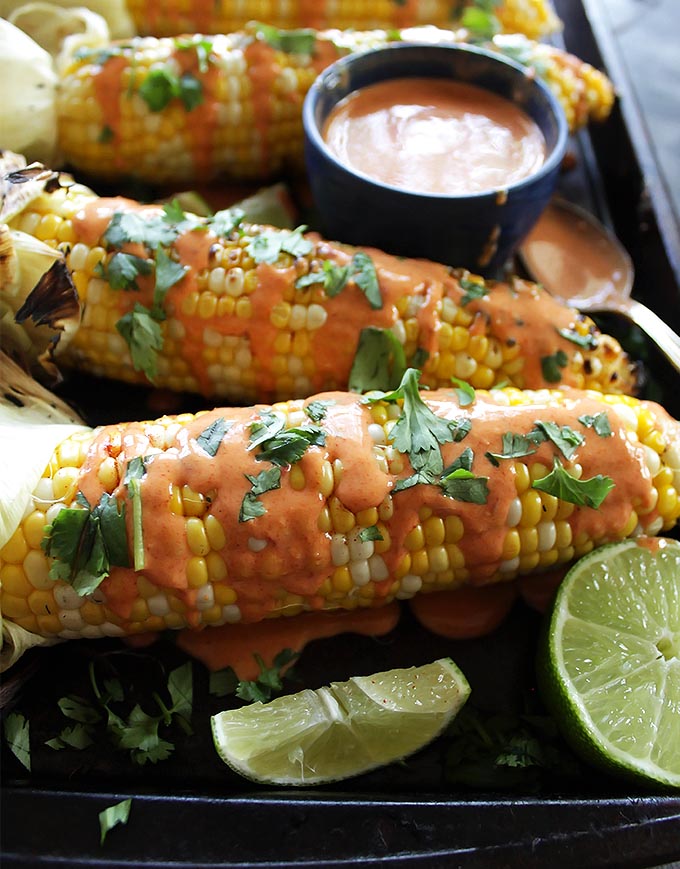 Grilled Corn with Spicy Chipotle Sauce - Move over butter! This spicy chipotle sauce is the perfect way to enjoy your sweet corn! This recipe is easy and perfect for summer parties! Vegetarian/gluten free.