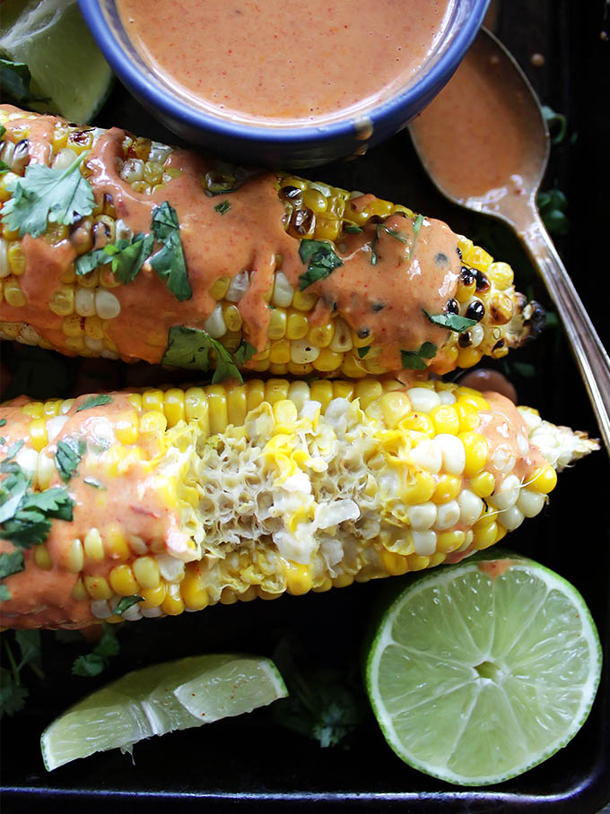 Grilled Corn with Spicy Chipotle Sauce - Sweet corn on the cob with an easy spicy chipotle sauce that's whipped up in the blender. This recipe is perfect for summertime parties. Vegetarian/gluten free.