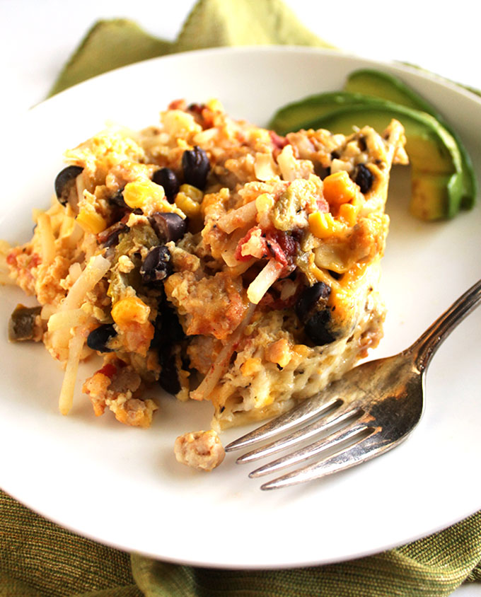 Mexican Crock Pot breakfast Casserole - An EASY healthy recipe that cooks while you sleep. Layers of cheesy hashbrowns, sausage, and all the Mexican goodies. Perfect for feeding a crowd or make ahead breakfasts! Gluten Free.