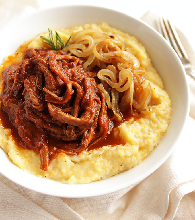 Slow Cooker Shredded Beef Sauce with Creamy Polenta - An uber flavorful, rich sauce made in the slow cooker and served over creamy polenta with goat cheese. This recipe is perfect for feeding a crowd or meal prep. It also freezes really well. Gluten Free | robustrecipes.com
