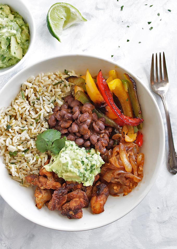 Chicken Fajita Bowls with Cilantro Lime Rice - Bowls packed with all of the BEST fajita ingredients: chicken, cilantro lime rice, sauteed peppers and onions, and guacamole! This recipe is HEALTHY and super flavorful! Gluten Free/Dairy Free | robustrecipes.com