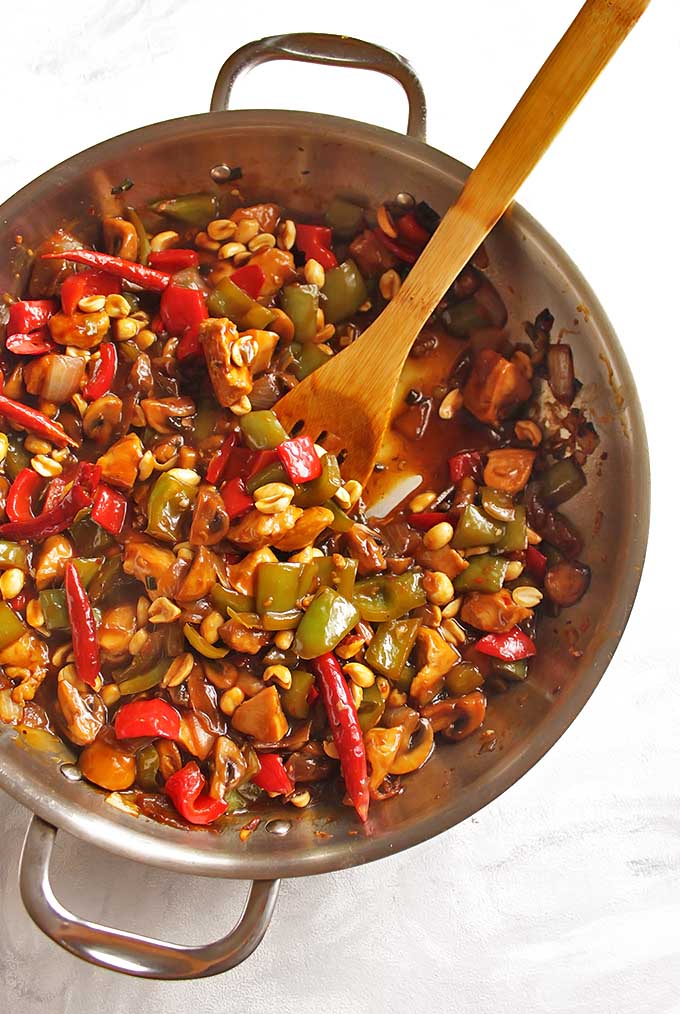 Healthy General Tso's Chicken - Sauteed chicken, onions, peppers, mushrooms, and peanuts in a sweet, salty, spicy sauce that is served over rice. This Asian inspired dish is perfect for weeknight dinners - only takes 30 minutes to make! Gluten Free/Dairy Free/Soy Free | robustrecipes.com