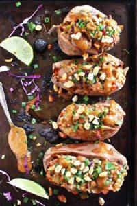 Thai Chicken Stuffed Sweet Potatoes with Peanut Sauce - Baked sweet potatoes loaded with veggies and all the Thai flavors and topped with a tangy, salty, sweet peanut sauce! This recipe is healthy, comforting, and satisfying! Gluten Free/Soy Free/Refined Sugar Free | robustrecipes.com