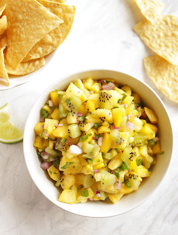 Tropical Fruit Salsa - A quick and flavorful fruit salsa that's a lot of sweet and a little savory. This recipe only requires 7 ingredients and 10 minutes to make! It goes great with tortilla chips for dipping or is delicious added on top of plain chicken, fish, or pork. It is even good on fish tacos! Gluten Free/Vegan/Vegetarian | robustrecipes.com