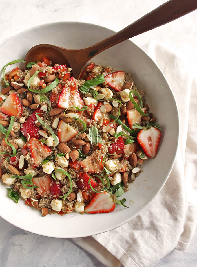 Strawberry Basil Quinoa Salad - great for summertime parties. It's a little sweet, a little savory and all of the summer-y goodness in one bowl - strawberries, fresh basil, mozzarella balls, toasted almonds! This recipe is easy to make, only 30 minutes! Gluten Free/Vegetarian | robustrecipes.com