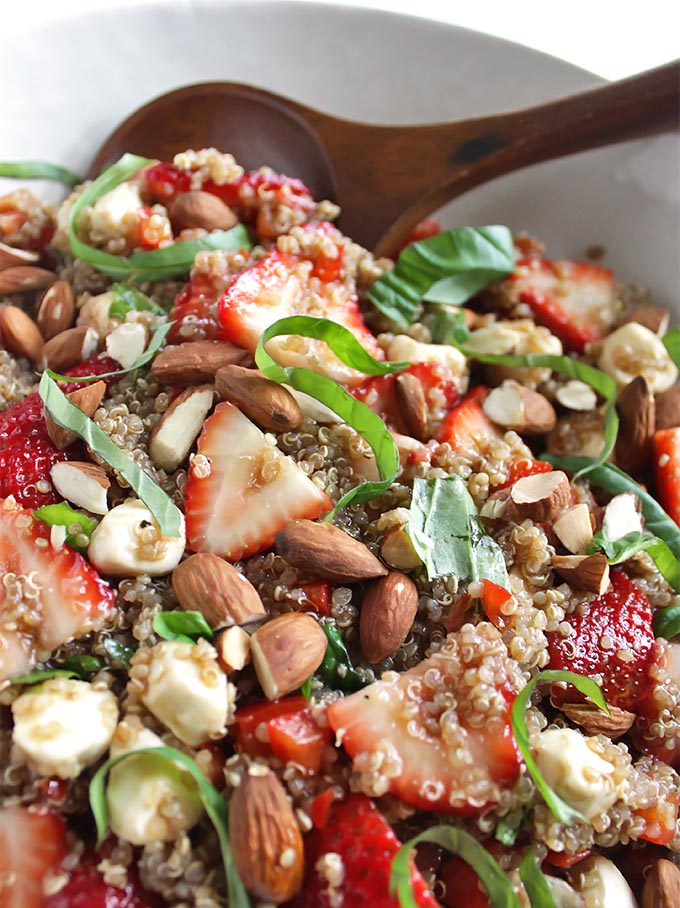 Spring Strawberry Basil Quinoa Salad - great for summertime parties. It's a little sweet, a little savory and all of the summer-y goodness in one bowl - strawberries, fresh basil, mozzarella balls, toasted almonds! This recipe is easy to make, only 30 minutes! Gluten Free/Vegetarian | robustrecipes.com