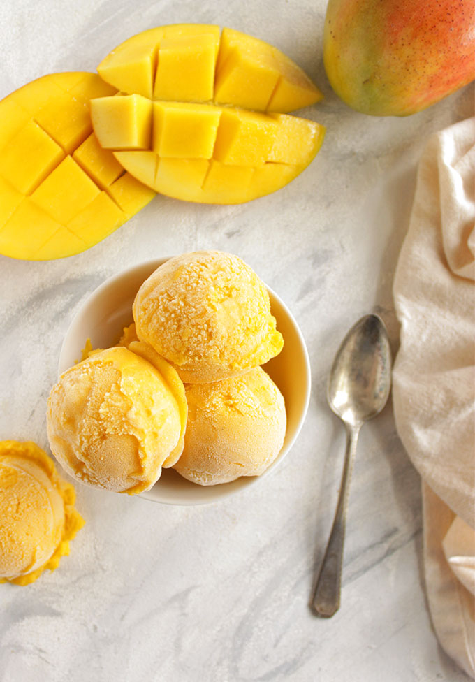 Creamy, sweet and slightly tangy with a hint of cardamom for that classic mango lassi taste. This frozen yogurt recipe is super easy to make, only 15 minutes of hands on time and no ice cream maker required! The perfect summertime treat. Gluten Free/Refined Sugar Free | robustrecipes.com
