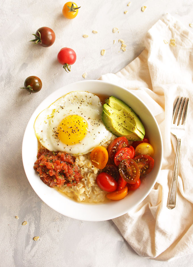 12 Minute Savory Oatmeal with Fried Eggs - A quick and easy breakfast that is perfect for weekday mornings. This savory oatmeal recipe is packed with protein, healthy carbs, fiber, healthy fats, and nutrition from the tomatoes. It will keep you fueled and satisfied until lunch. One of my favorite weekday breakfasts during the fall and winter. (Gluten Free and Vegetarian). | robustrecipes.com