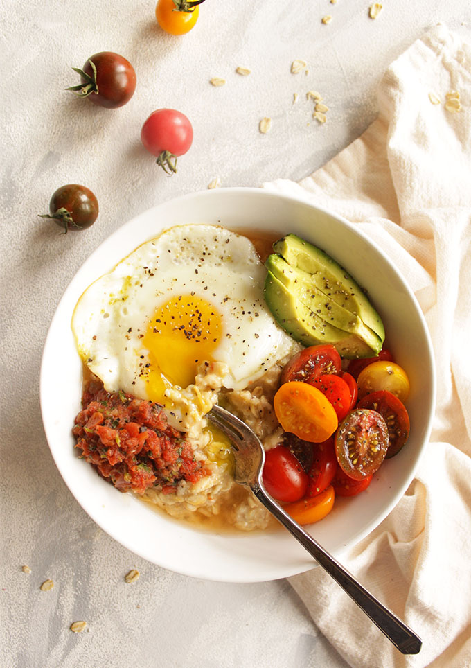 12 Minute Savory Oatmeal with Fried Eggs - A quick and easy breakfast that is perfect for weekday mornings. This savory oatmeal recipe is packed with protein, healthy carbs, fiber, healthy fats, and nutrition from the tomatoes. It will keep you fueled and satisfied until lunch. One of my favorite weekday breakfasts during the fall and winter. (Gluten Free and Vegetarian). | robustrecipes.com