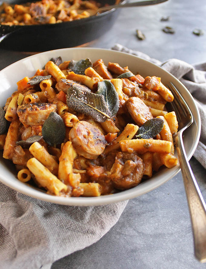 Gluten Free Pumpkin Pasta with Sausage and Crispy Fried Sage - Pumpkin pasta with a thick savory pumpkin sauce, sweet apple chicken sausage, and topped with crispy fried sage leaves. The ultimate recipe for fall comfort food! Only takes 35 minutes to make! One of our favorite fall meals. | robustrecipes.com