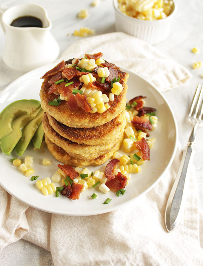 Cornmeal Pancakes with Bacon and corn (gluten free) - Savory cornmeal pancakes that are topped with crispy, salty bacon, fresh corn kernels, avocado slices, chives and a drizzle of maple syrup. These pancakes are that perfect balance of savory with a hint of sweetness. The ultimate weekend morning breakfast, especially when served along side some eggs. This recipe is dairy free adaptable and gluten free! So yum! | robustrecipes.com