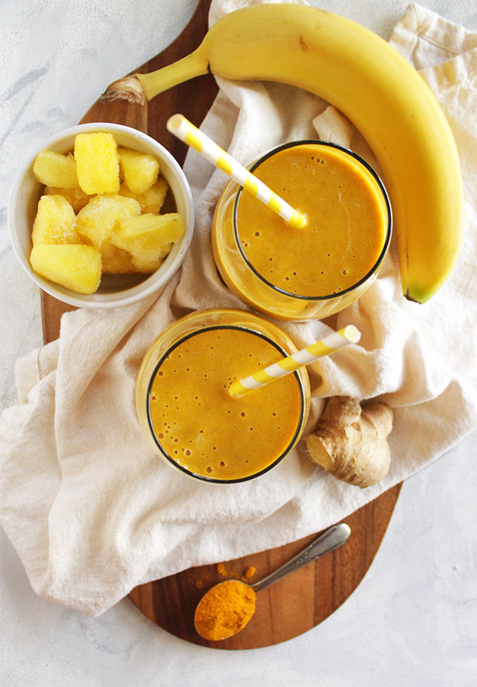 Pineapple ginger turmeric smoothie - a refreshing version of golden milk. It's sweet, tropical, ginger-y and warming from that turmeric. Plus it is packed with health benefits: aids in digestion, packed with vitamin c, anti-inflammatory properties, and healthy fats. Great for when you are feeling sick or under the weather. So yum! (Vegan/Gluten Free/ Dairy Free) | robustrecipes.com