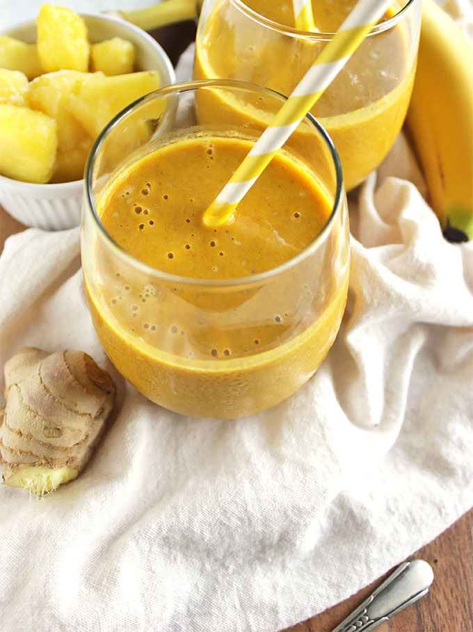 Pineapple ginger turmeric smoothie - a refreshing version of golden milk. It's sweet, tropical, ginger-y and warming from that turmeric. Plus it is packed with health benefits: aids in digestion, packed with vitamin c, anti-inflammatory properties, and healthy fats. Great for when you are feeling sick or under the weather. So yum! (Vegan/Gluten Free/ Dairy Free) | robustrecipes.com