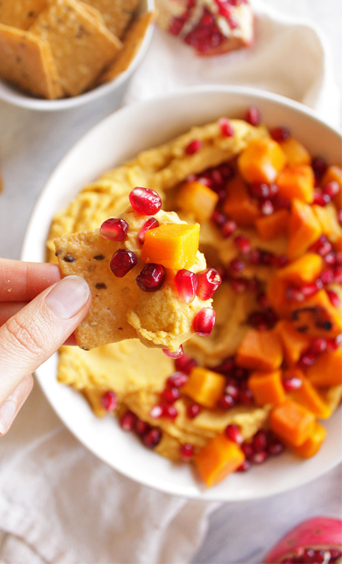 Loaded Butternut Squash Hummus with Pomegranate - Hummus that is packed with roasted butternut squash and topped with more butternut squash chunks and pomegranate seeds. Serve with crackers for dipping. Makes for the perfect Thanksgiving or Christmas appetizer. It's also great because it can mostly be made ahead and served room temperature or cold. (vegan/gluten free) | robustrecipes.com