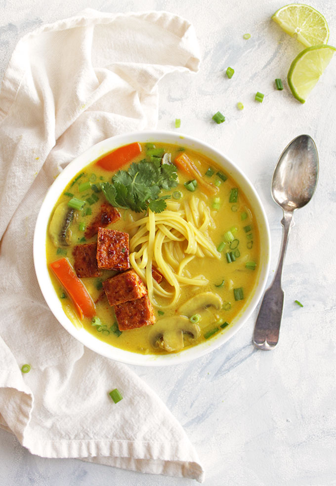 Thai curry soup, sauteed mushrooms, bell peppers, onions, and rice noddles in a creamy curry broth. And topped with crispy tofu. Only takes 30 minutes to make, the perfect weeknight dinner recipe, especially in the winter! (Vegan, Gluten Free, Vegetarian) | robustrecipes.com