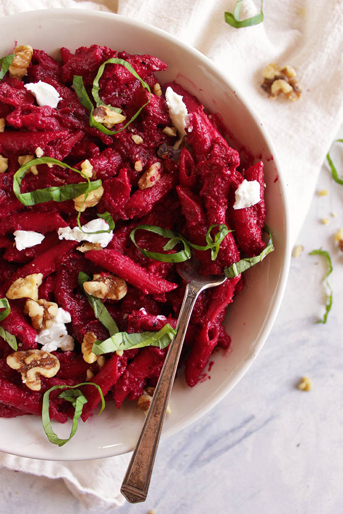 Tender pasta with thick roasted beet and goat cheese sauce that's earthy, tangy, and sweet. The pasta salad is topped with crushed walnuts and fresh basil. Perfect for parties. So yum! (Gluten Free/Vegetarian) | robustrecipes.com
