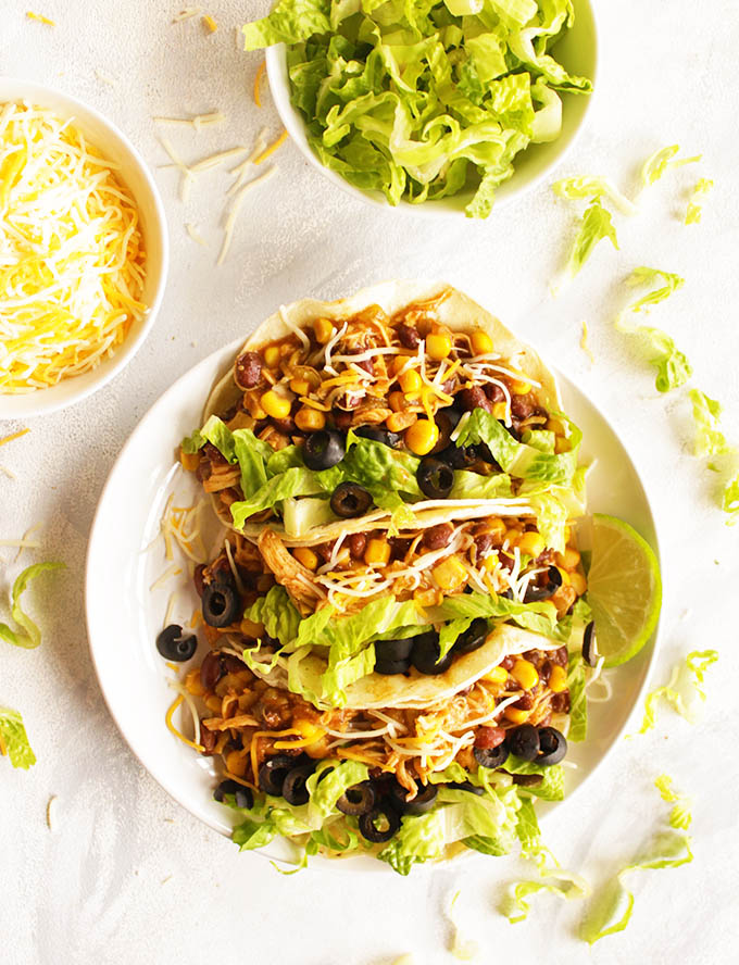 Instant pot chicken tacos are juicy and bursting with flavor. The easiest taco recipe you will ever make. Perfect for feeding a crowd of for eating as leftovers during the week, or as meal prep. Add any of your favorite taco fixings and the ultimate taco night is yours in no time! The chicken taco meat also makes great quesadillas!!! (Gluten Free) | robustrecipes.com