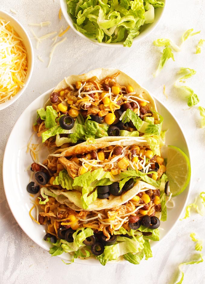 Instant pot chicken tacos are juicy and bursting with flavor. The easiest taco recipe you will ever make. Perfect for feeding a crowd of for eating as leftovers during the week, or as meal prep. Add any of your favorite taco fixings and the ultimate taco night is yours in no time! The chicken taco meat also makes great quesadillas!!! (Gluten Free) | robustrecipes.com