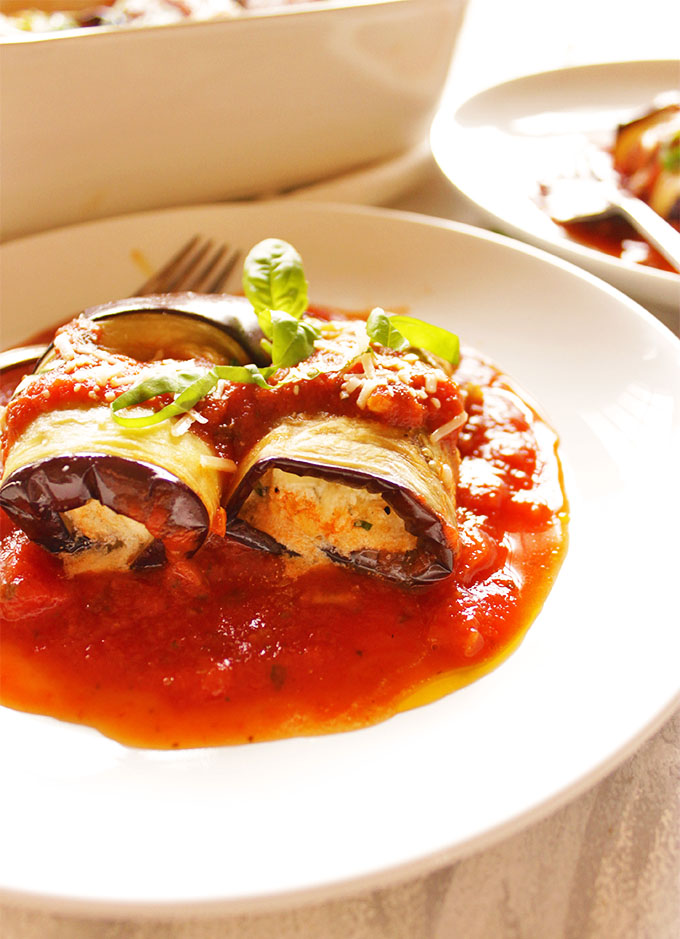 Easy eggplant lasagna roll ups are a fun and simple way to enjoy all of the lasagna tastes and feels - minimal assembly required. Tender roasted eggplant with creamy ricotta cheese and marinara sauce - so yum! (Gluten free & Vegetarian). #Glutenfree #lasagna #eggplant #healthyfood #vegetarian