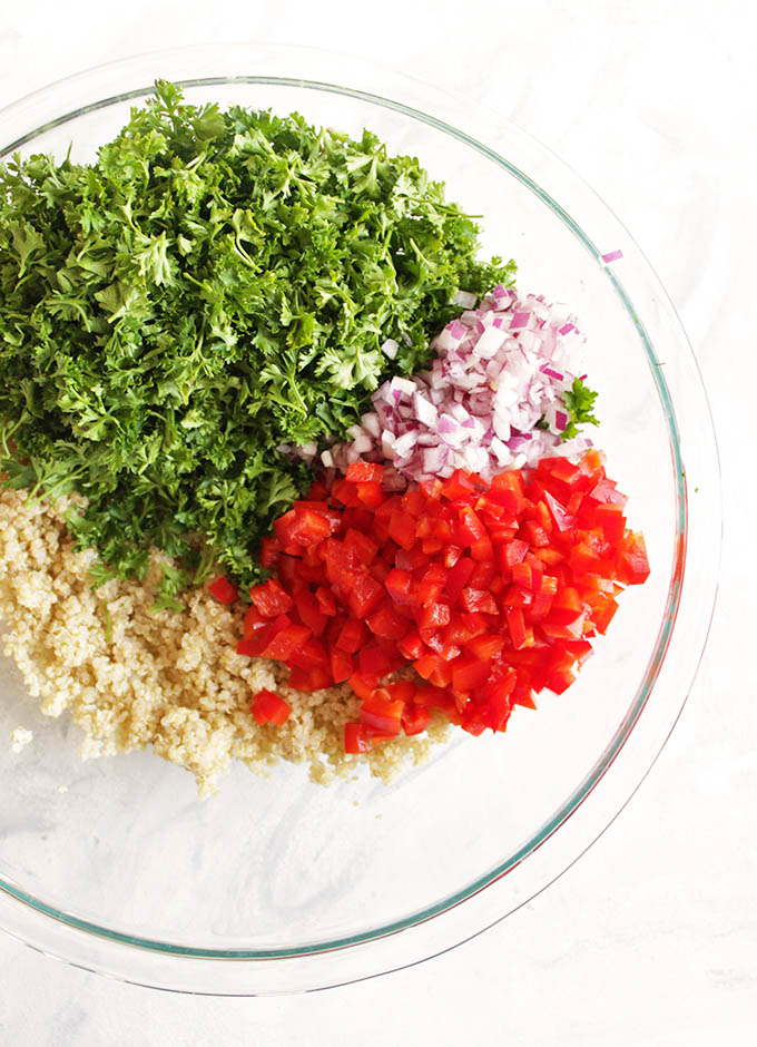 Quinoa tabbouleh salad is a gluten free twist on the traditional Middle Eastern dish. It's packed with parsley, mint, red onion, cucumbers, red pepper, and tossed in a simple lemon & olive oil dressing. It's best when made in advance making it perfect for packed lunches or bringing to parties. (Vegetarian & Gluten Free) | robustrecipes.com