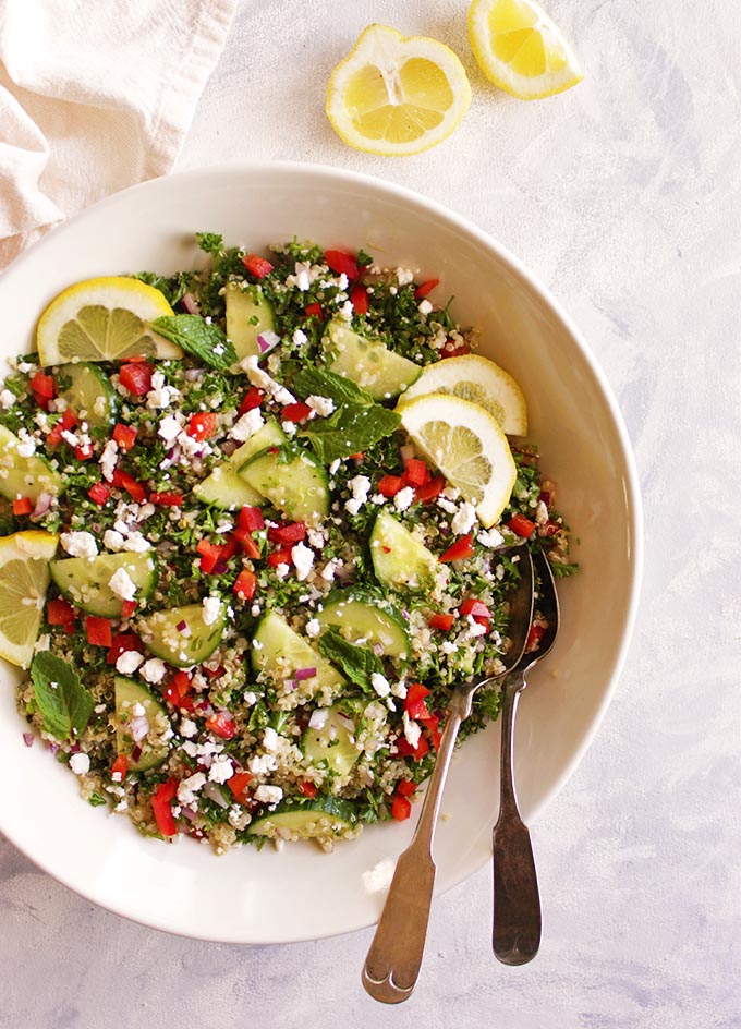 Quinoa tabbouleh salad is a gluten free twist on the traditional Middle Eastern dish. It's packed with parsley, mint, red onion, cucumbers, red pepper, and tossed in a simple lemon & olive oil dressing. It's best when made in advance making it perfect for packed lunches or bringing to parties. (Vegetarian & Gluten Free) | robustrecipes.com