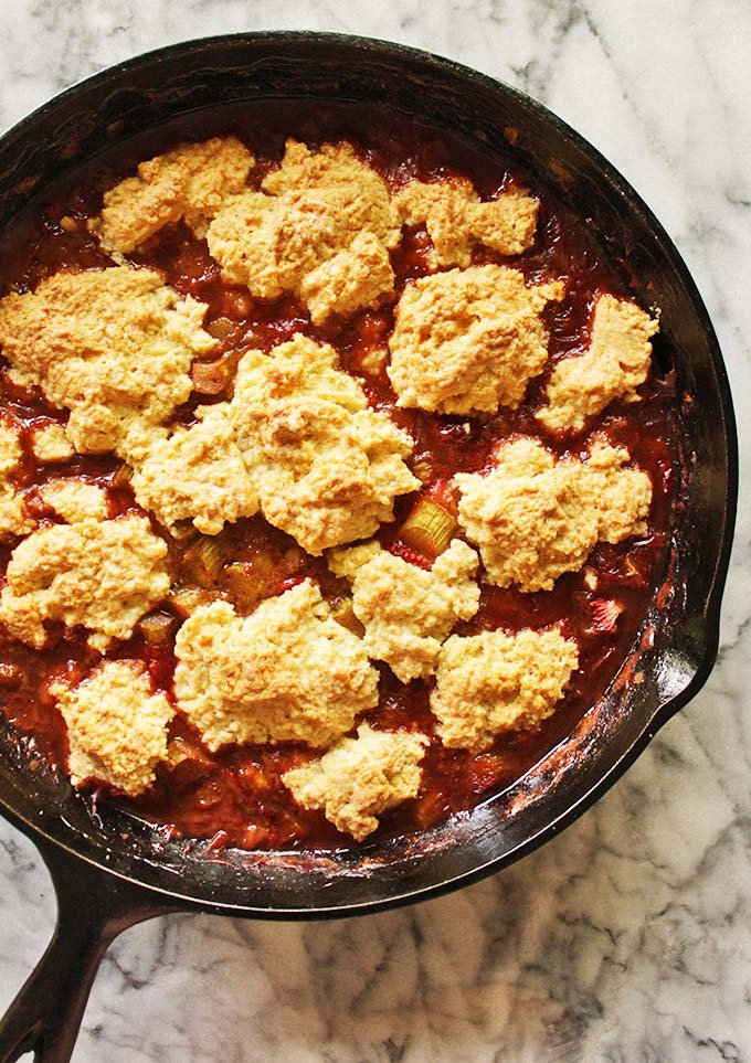Strawberry rhubarb cobbler with a gluten free biscuit topping. Best served warm, with vanilla ice cream and shared with friends! The perfect spring & summer dessert. #glutenfree #vegan #dairyfree #strawberryrhubarb #cobbler #summer #spring #icecream | RobustRecipes.com