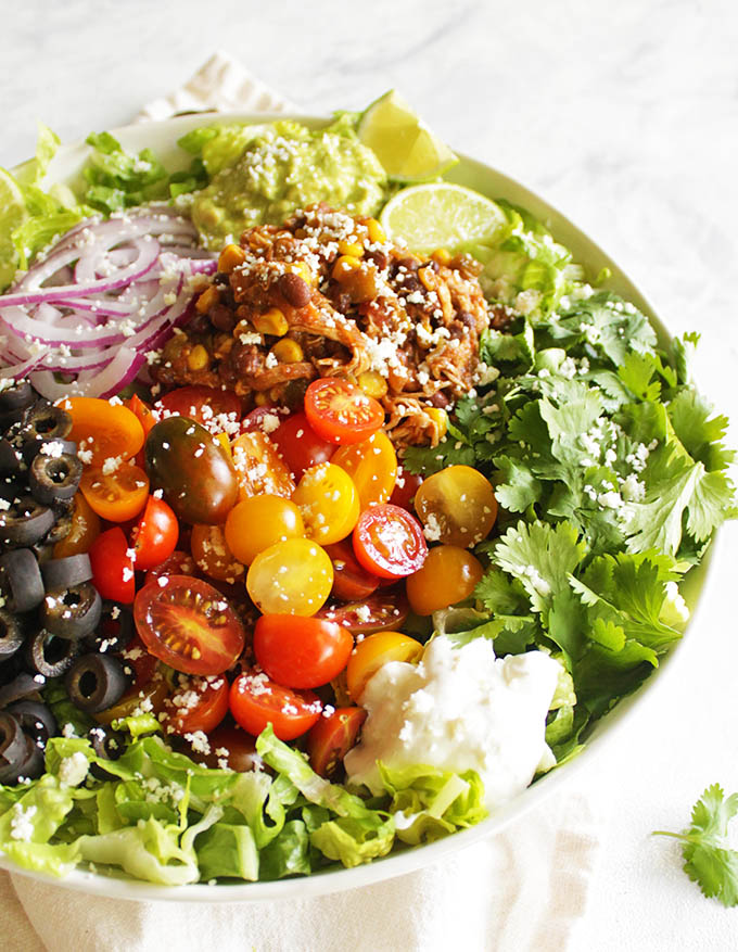 The Best Chicken Taco Salad - A much tastier, and healthier version of the typical taco salad you will find in restaurants. Romaine lettuce is loaded with a saucy chicken taco meat that's make in the instant pot + all of your favorite taco fixings. Easy to make and perfect for a weeknight meal. #tacosalad #chicken #glutenfree #weeknightmeal | robusrecipes.com