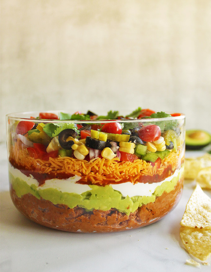11 Layer Taco Dip - the perfect appetizer for any party any time of year. It's creamy, crunchy, and loaded with veggies. It only takes 20 minutes to make!  #appetizer #glutenfree #vegetarian #recipe #easyrecipe