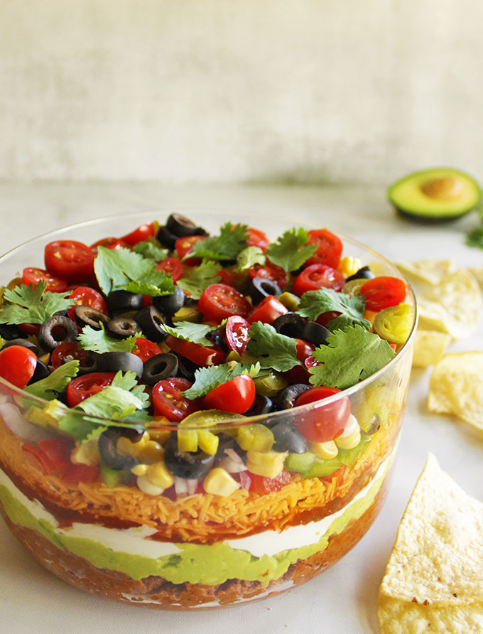 11 Layer Taco Dip - the perfect appetizer for any party any time of year. It's creamy, crunchy, and loaded with veggies. It only takes 20 minutes to make!  #appetizer #glutenfree #vegetarian #recipe #easyrecipe