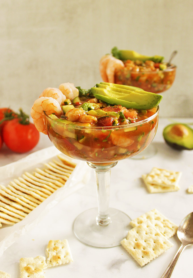 Mexican shrimp cocktail - a refreshing summertime entree or appetizer. It has a tomato based sauce that's loaded with crunchy veggies, avocado, and perfectly cooked shrimp. #shrimp #avocado #summer #recipe 