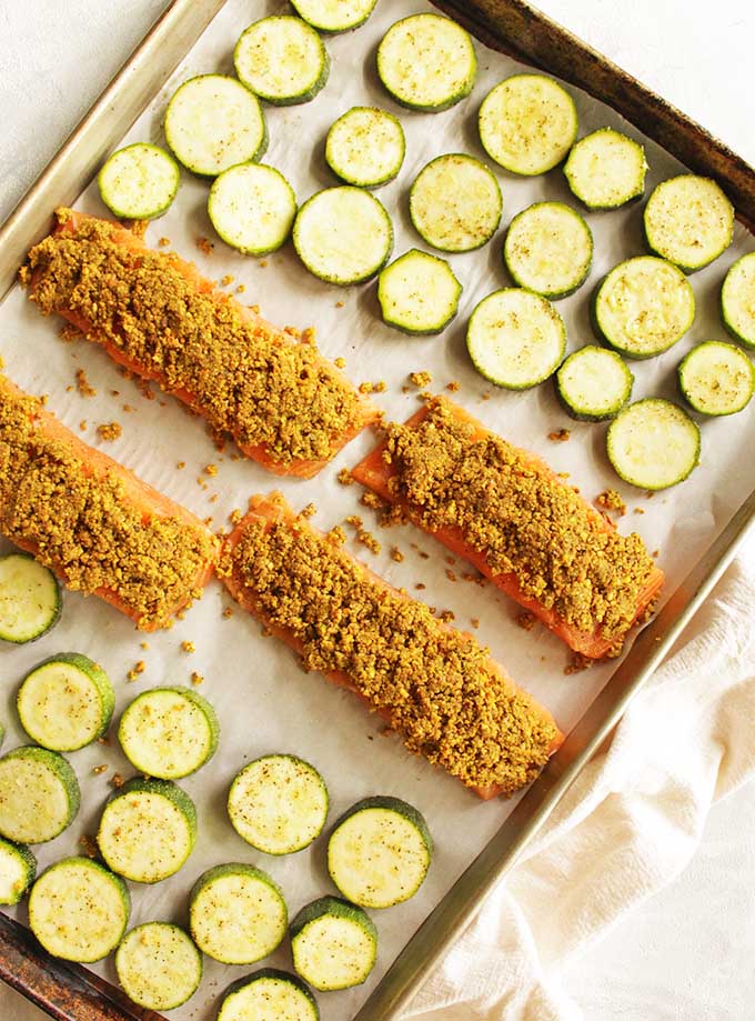 Pistachio crusted salmon is roasted salmon topped with a pistachio crust. This dinner is perfect for any busy weeknight. It only takes 30 minutes to make and 1 sheet pan. The zucchini is roasted right along side the salmon making it a complete meal. #glutenfree #dairyfree #weeknightrecipe #easyrecipe #salmon #30minutemeal