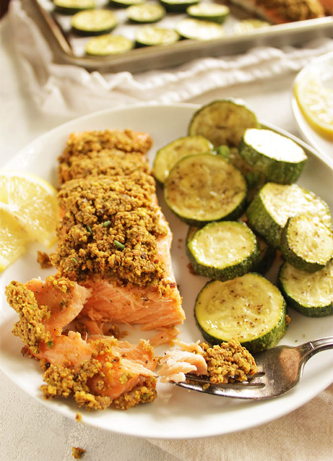 Pistachio crusted salmon is roasted salmon topped with a pistachio crust. This dinner is perfect for any busy weeknight. It only takes 30 minutes to make and 1 sheet pan. The zucchini is roasted right along side the salmon making it a complete meal. #glutenfree #dairyfree #weeknightrecipe #easyrecipe #salmon #30minutemeal