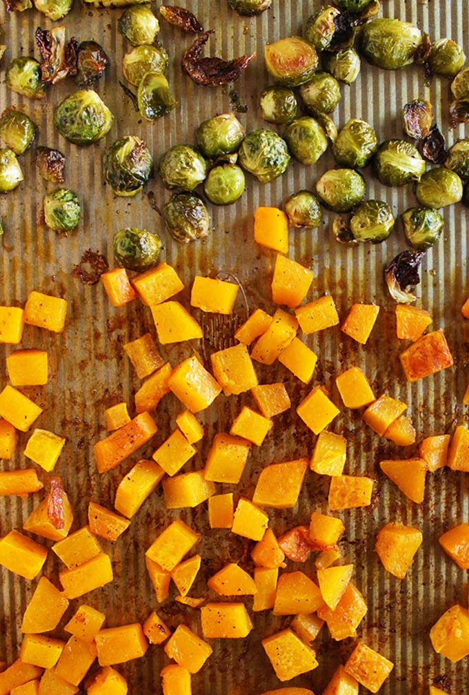 Roasted butternut squash and Brussels sprouts is the perfect side for Thanksgiving or any fall time meal. Orange, honey glazed butternut squash with crispy Brussels sprouts and crunchy pomegranate! #Thanksgiving #easyrecipes #recipes #glutenfree #vegan | robustrecipes.com