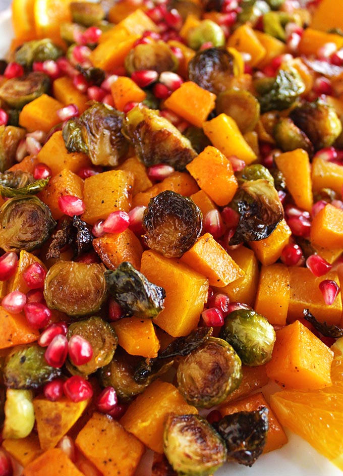 Roasted butternut squash and Brussels sprouts is the perfect side for Thanksgiving or any fall time meal. Orange, honey glazed butternut squash with crispy Brussels sprouts and crunchy pomegranate! #Thanksgiving #easyrecipes #recipes #glutenfree #vegan | robustrecipes.com