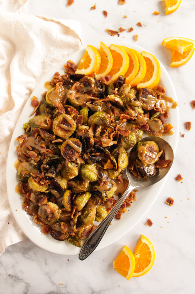 Brussels Sprouts and Bacon with Orange Tahini Sauce has all the flavors, savory, salty, and sweet. It makes the perfect fall or Thanksgiving side dish to any meal. #easyrecipe #bacon #Thanksgiving #brusselspsrouts #glutenfree | robustrecipes.com